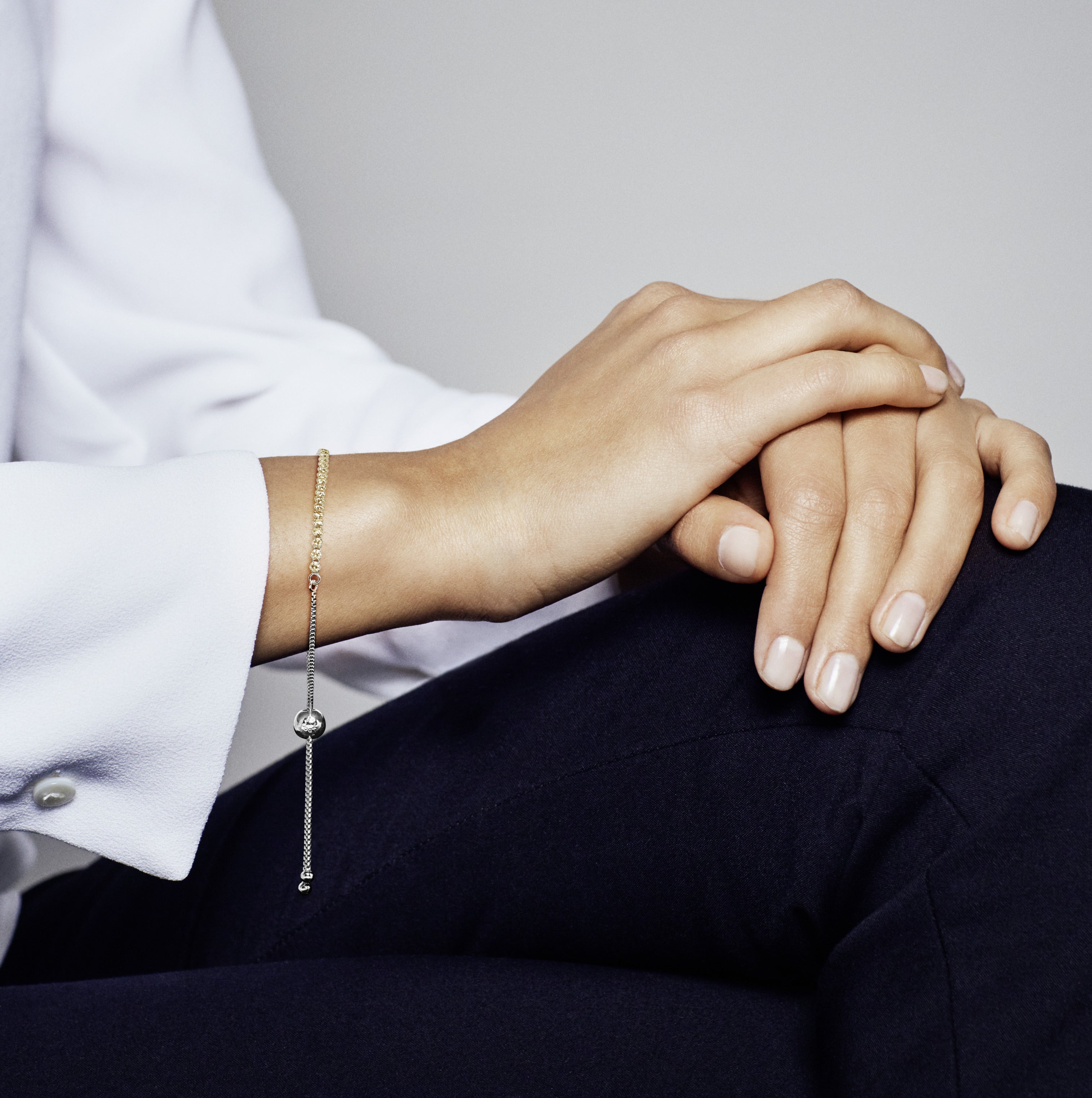 Rhodium plated silver bracelet with golden coloured cubic zirconia