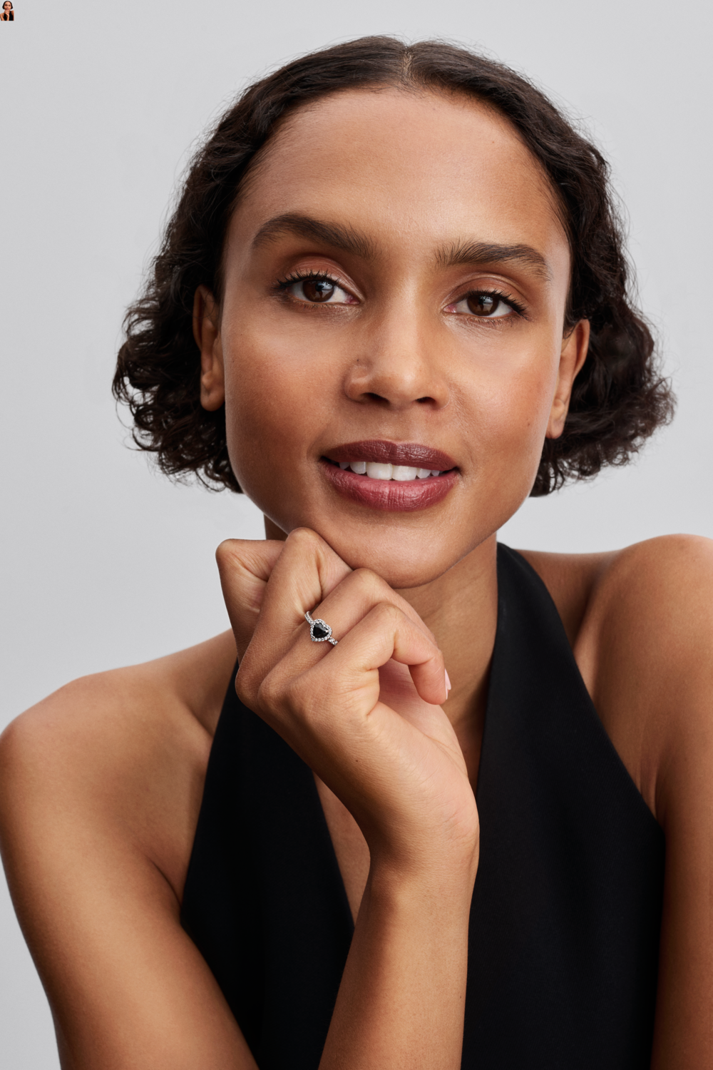 A bold black heart stone sits at the center of this striking ring, framed by shimmering pavé