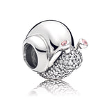 Snail silver charm with clear cubic zirconia and orchid pink crystal