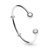 Silver open bangle with silicone stoppers and interchangeable end caps
