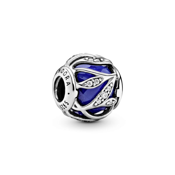 Abstract silver charm with faceted royal blue crystal and clear cubic zirconia