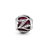 Abstract silver charm with faceted synthetic ruby and clear cubic zirconia